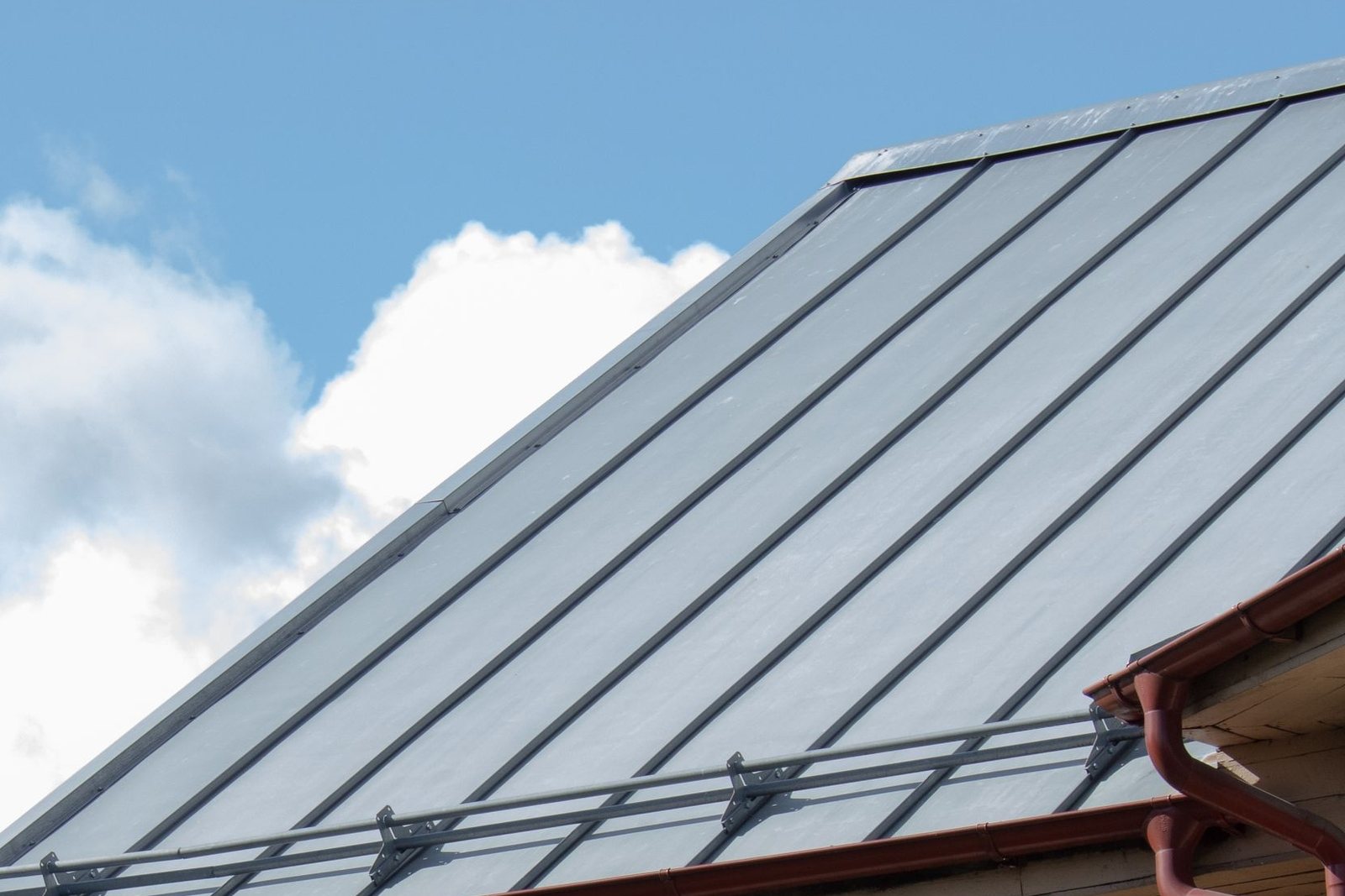 Standing seam metal roof panels with hidden fasteners