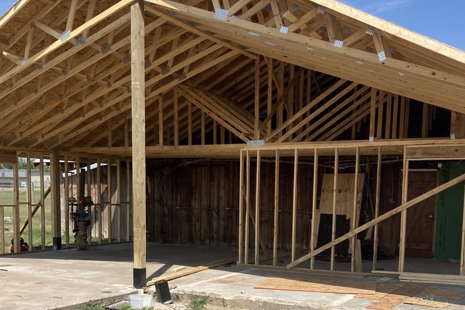 Wood post frame building going up with the roof framing in place