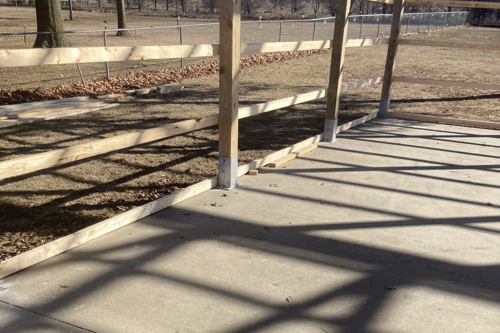 Wood posts and wall girts set on a finished concrete slab